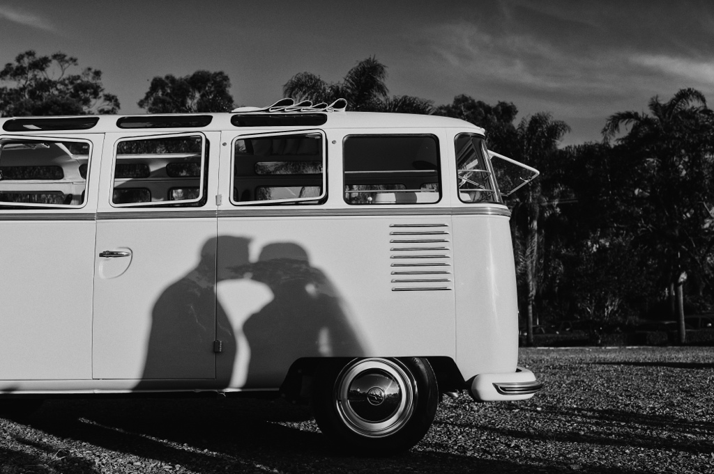 couple kissing in the shadow with Lola the Gold coast kombi